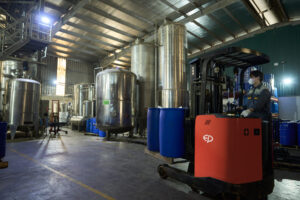 A modern distillation plant, featuring advanced stainless steel distillation systems or a clean, organized manufacturing environment.